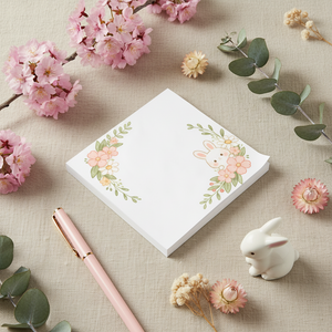 A square white notepad with a cute bunny illustration and pink floral accents in the corners, shown on a clean white background.