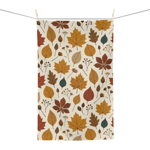DipaliZ fall tea towel hung over an oven handle in a warm kitchen