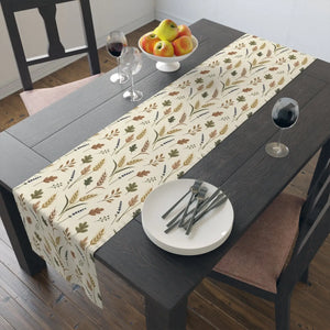 Botanical sprig repeat in warm neutrals along a DipaliZ table runner