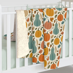 Squash and pumpkins in muted orange and teal on a DipaliZ sherpa throw