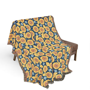 Sunflower patterned throw blanket draped over a chair on a white background
