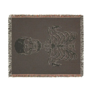 Woven blanket from DipaliZ carrying a bone-white skeleton on a dark ground