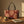 A tote bag with a burgundy and beige damask pattern, featuring black shoulder straps, shown against a plain white background.