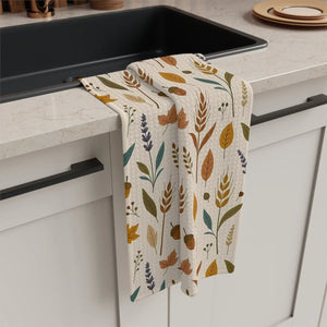 Gold, rust and teal autumn leaves printed on a DipaliZ microfiber tea towel