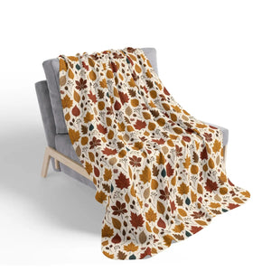 Burnt orange and olive leaves on a heavy DipaliZ sherpa fleece blanket
