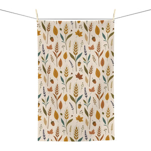 DipaliZ autumn leaves tea towel folded beside kitchen glassware