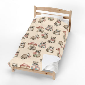 A single wooden bed frame with a cream-colored bedding set featuring a repeating pattern of illustrated raccoons and red-and-white mushrooms, photographed on a clean white background.