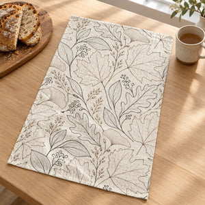 Raised waffle weave carrying bold leaf silhouettes on a DipaliZ hand towel