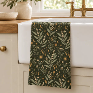 Moon phases running in a band among herbs on a DipaliZ kitchen towel