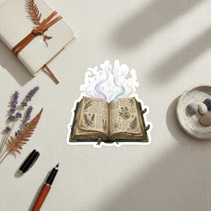 Open vintage grimoire kiss-cut sticker by DipaliZ with dried herbs