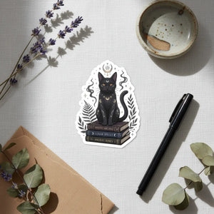 Black cat on a stack of spellbooks, kiss-cut vinyl sticker by DipaliZ