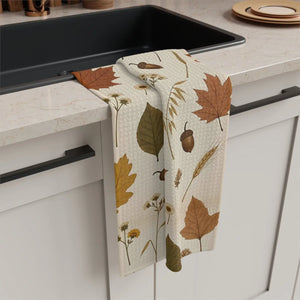 Rust leaves, acorns and dried blooms printed on a DipaliZ tea towel