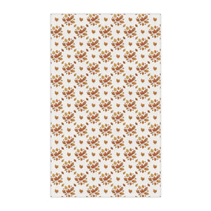 Scattered fall leaf artwork across a DipaliZ kitchen tea towel