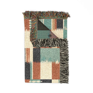 Patchwork grid artwork by DipaliZ, printed edge to edge on a woven blanket