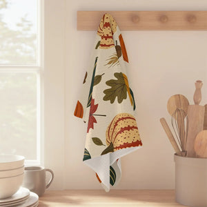 Cream-ground harvest tea towel from DipaliZ folded for a farmhouse kitchen