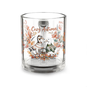 Two rounded ducks printed around the clear glass body of a DipaliZ mug