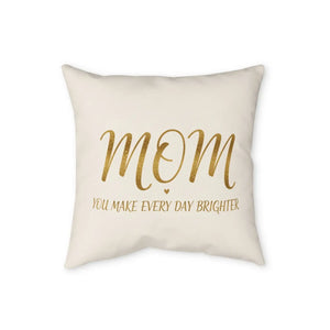 Warm gold type on a neutral ground across a DipaliZ decorative pillow