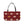 A rectangular tote bag with a dark red background, featuring a repeating pattern of cream-colored stylized pine trees and small gold stars, with black shoulder straps, shown against a plain white background.