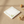 A square white notepad with a watercolor-style floral border in green and yellow, featuring a small frog illustration in the lower right corner, shown on a clean white background.
