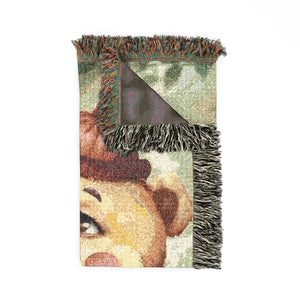 Bear woven blanket folded on a bed