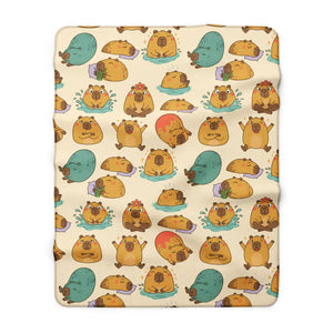 Close detail of the round capybara illustration on the DipaliZ sherpa blanket