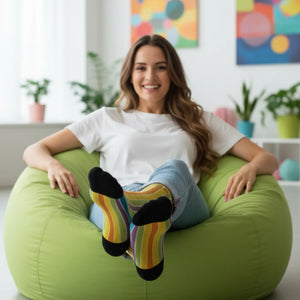 Cats sitting along horizontal rainbow stripes on DipaliZ socks