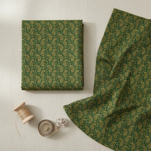 Flat lay of DipaliZ green paisley spun polyester fabric by the yard